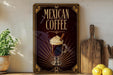 A decorative sign for Mexican coffee, featuring an illustration of a coffee drink with whipped cream and cinnamon sticks, is displayed on a shelf next to a wooden cutting board and a potted plant.