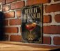 A sign for a Mexican Frying Squad cocktail is displayed on a brick wall.