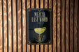 a poster with the text "MEZCAL LAST WORD" and an illustration of a cocktail glass with a lime on the poster.