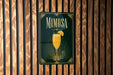 A sign for mimosa is displayed on a wooden wall.