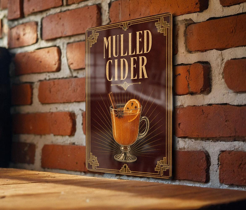 A sign for "Mulled Cider" is displayed on a brick wall, featuring an illustration of a glass of mulled cider with an orange slice.