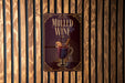 A poster advertising "Mulled Wine" is displayed on a wooden wall.