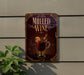 A sign on a wall advertising "Mulled Wine", featuring an illustration of a glass of wine with a slice of orange and a cinnamon stick.