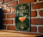 a sign with the text "Naked and Famous" and an illustration of a cocktail glass.