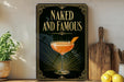 a framed poster with the text "Naked and Famous" and an illustration of a cocktail glass with a garnish.