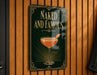 A sign that reads "Naked and Famous" with an illustration of a cocktail on a green background.