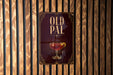 a sign with the text "OLD PAL" and an illustration of a glass containing a red liquid, likely a cocktail or wine.