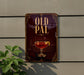 a sign with the word "OLD PAL" prominently displayed, along with an illustration of a glass containing a red liquid, possibly a cocktail or wine.