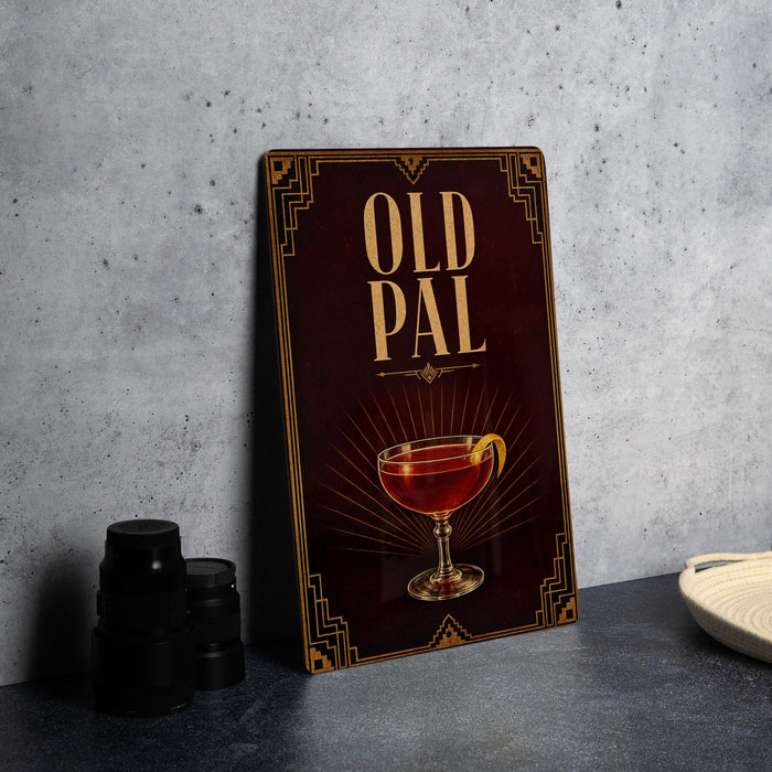 A framed poster with the text "OLD PAL" and an illustration of a cocktail on a dark background.