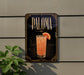 A sign for "Paloma" cocktail is displayed on a wall, featuring an illustration of a cocktail glass with a slice of orange.