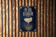 A sign for "Pearl Harbor" is displayed on a wooden wall.