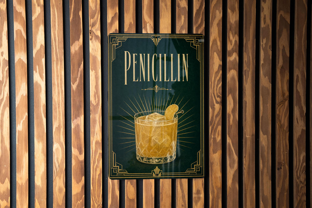 A sign for "Penicillin" cocktail is displayed on a wooden wall.