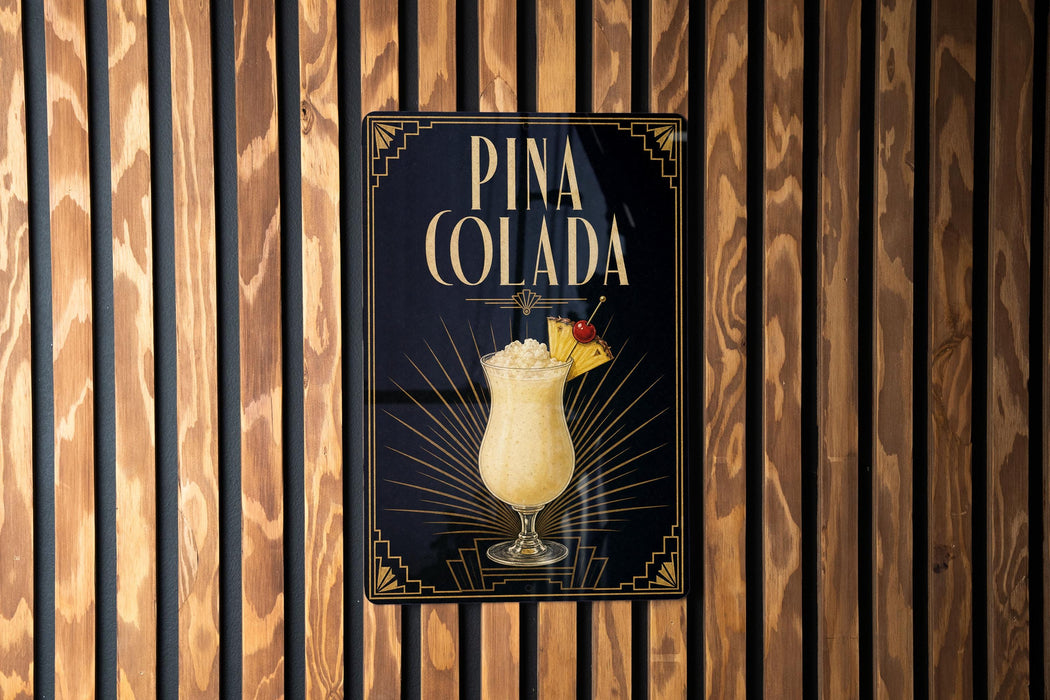 A sign for Pina Colada, featuring an illustration of a tropical drink in a glass with a straw and a pineapple on top, is displayed on a wooden wall.