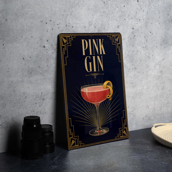 A framed poster with an illustration of a pink gin cocktail on a dark background, accompanied by the text "PINK GIN" in a decorative font.
