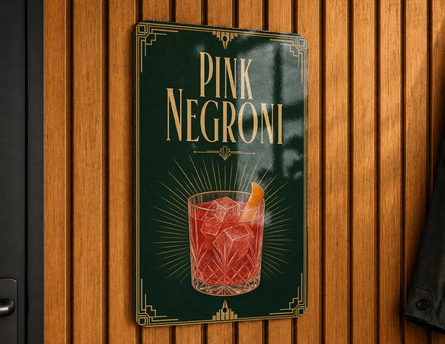 A sign for "PINK NEGRONI" cocktail, featuring an illustration of a pink cocktail with an orange slice.