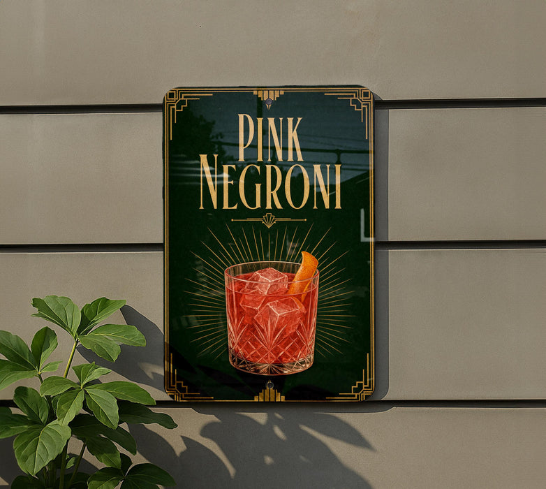 A sign for "PINK NEGRONI" cocktail, featuring a glass of the drink with an orange slice.