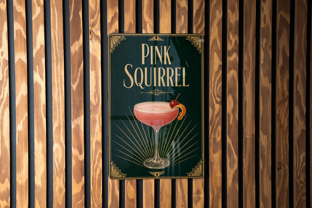 A poster advertising a pink squirrel cocktail is displayed on a wooden wall.