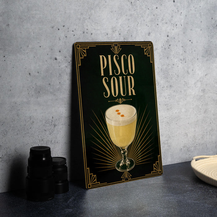 A framed poster or sign displaying a cocktail called "Pisco Sour" with an illustration of a glass containing the drink.
