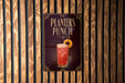 A sign for "Planners Punch" is displayed on a wooden wall.
