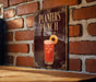 A sign for "Planters Punch" is displayed on a brick wall, featuring an illustration of a cocktail with a cherry on top.