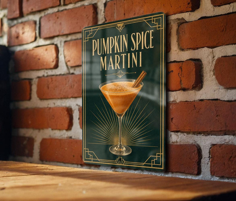 A sign for a pumpkin spice martini is displayed on a brick wall.