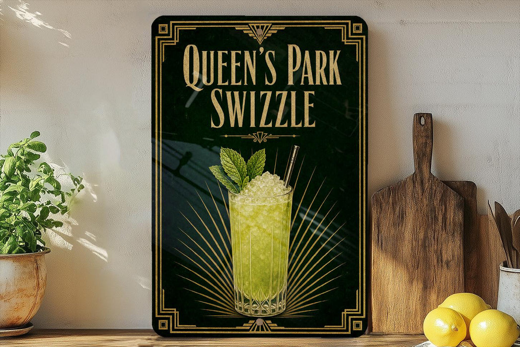 A framed advertisement for "Queen's Park Swizzle" featuring a glass of a yellow-green drink garnished with mint leaves and a straw.