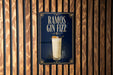 A poster advertising "RAMOS GIN FIZZ" is displayed on a wooden wall.
