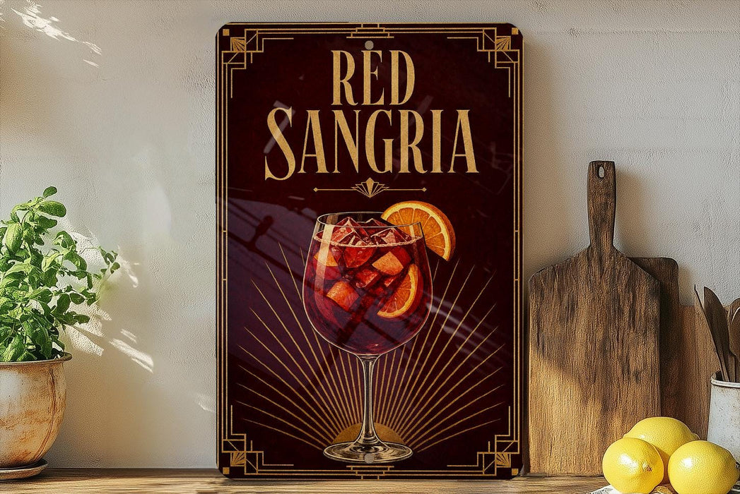 A decorative sign for "Red Sangria" featuring a glass of red wine with orange slices, placed on a wooden surface next to a wooden cutting board and a potted plant.