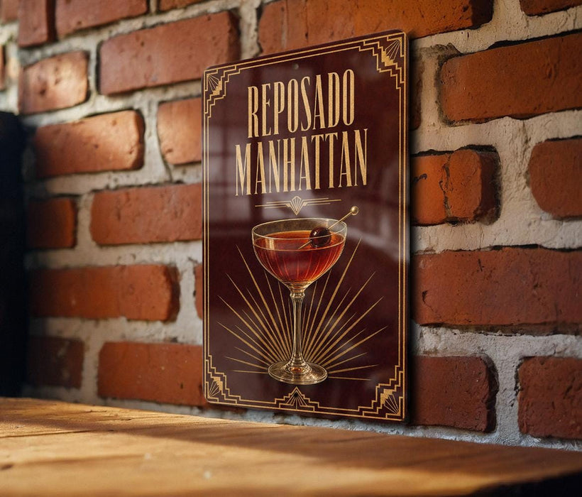 A poster or sign for "Reposado Manhattan" is displayed on a brick wall, featuring an illustration of a cocktail glass with a cherry.