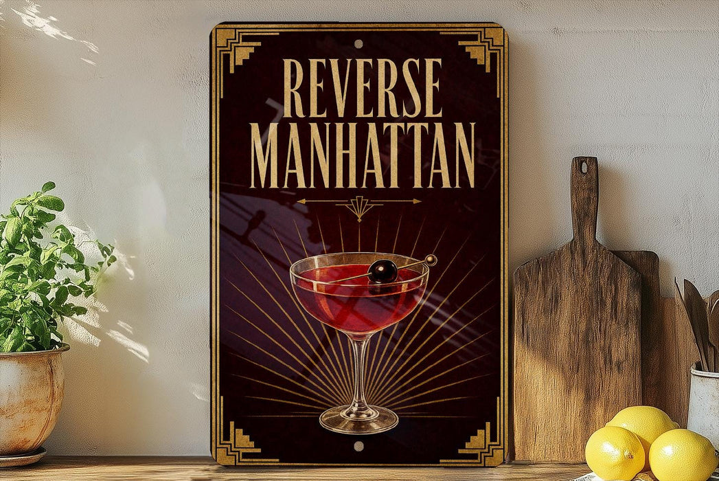 a decorative sign with the text "Reverse Manhattan" and an illustration of a martini glass with a cherry on top.
