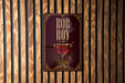 A poster with the name "ROB ROY" displayed prominently, along with an illustration of a martini glass.