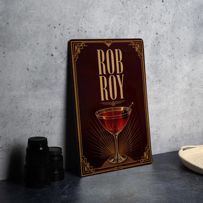 a framed poster with a red background and gold accents, displaying an illustration of a martini glass with a red drink inside.