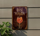 A sign for "Rose Sangria" is displayed on a wall, featuring an illustration of a glass filled with a pink drink and garnished with orange slices.