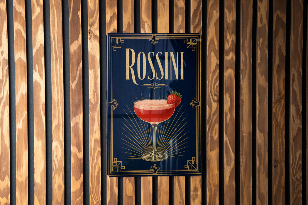 A poster for "ROSSINI" cocktail, featuring a glass of red cocktail with a strawberry garnish, against a wooden background.