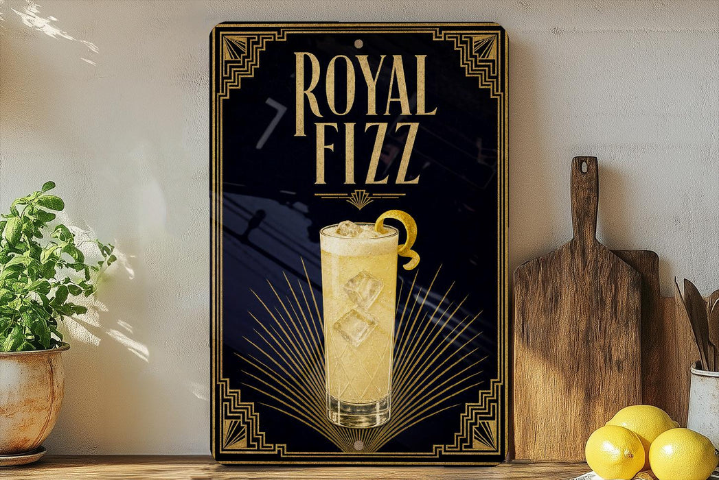 A decorative sign for Royal Fizz cocktail, featuring a glass of the drink and a lemon slice, is displayed on a wooden shelf next to a potted plant and a cutting board.