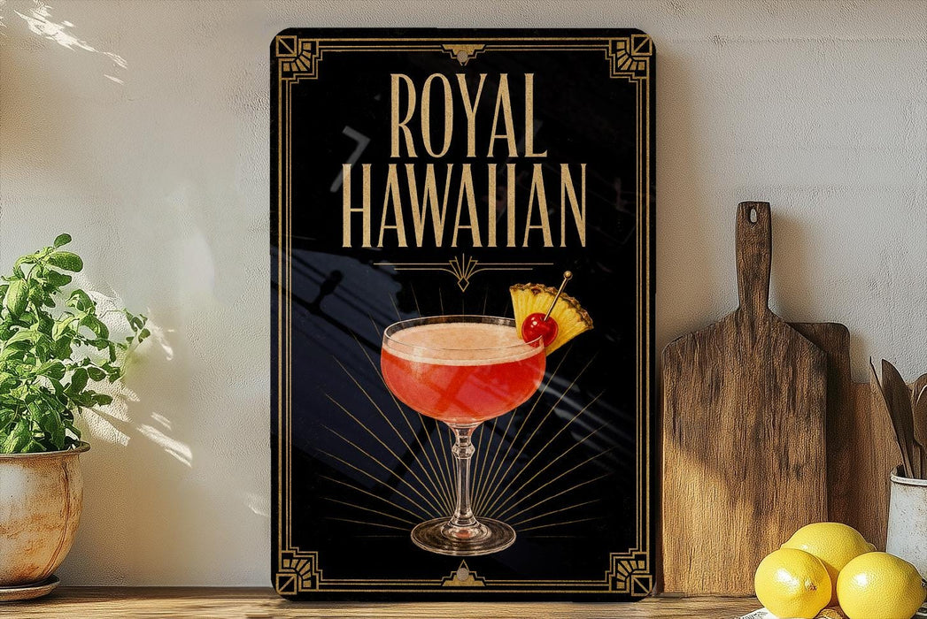A framed poster of a Royal Hawaiian cocktail is displayed on a wall, with a wooden cutting board and a potted plant to the side.