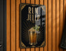 A sign for a rum julep cocktail is displayed on a wooden wall.