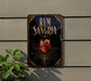 a sign for "RUM SANGRIRA" with a glass of rum and orange slices, placed on a wall next to a plant.