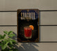 A decorative sign for a Sangrita cocktail, featuring an illustration of a glass filled with a red drink and an orange slice.