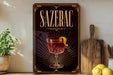 a decorative sign for a drink called "Sazerac" with a glass illustration and a lemon peel.