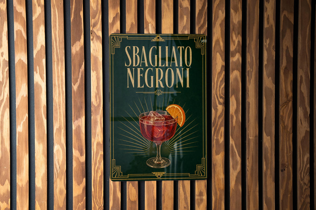 A sign for "Sbagliato Negroni", a type of Italian cocktail, is displayed on a wooden wall.