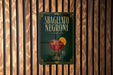 A sign for "Sbagliato Negroni", a type of Italian cocktail, is displayed on a wooden wall.