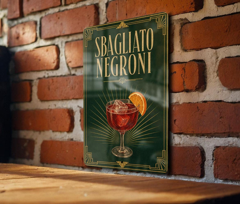 A sign with the text "SBAGLIATO NEGRONI" and an illustration of a glass of Negroni, a famous Italian cocktail, is displayed on a brick wall.