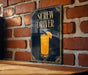 A poster with the title "SCROW DRIVER" and an illustration of a cocktail glass with a lemon slice.
