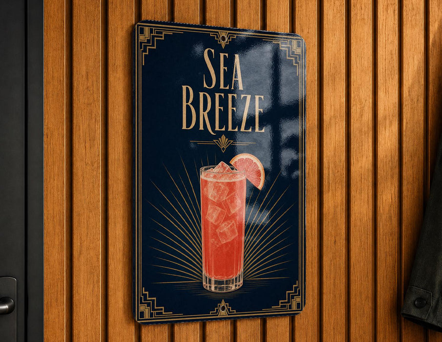 A sign for a Sea Breeze cocktail is displayed on a wooden wall.