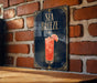 a sign with the text "SEA Breeze" and an illustration of a cocktail with a slice of lemon.