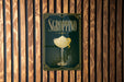 A poster with the word "SGROPPINO" and an illustration of a cocktail glass is displayed on a wooden wall.