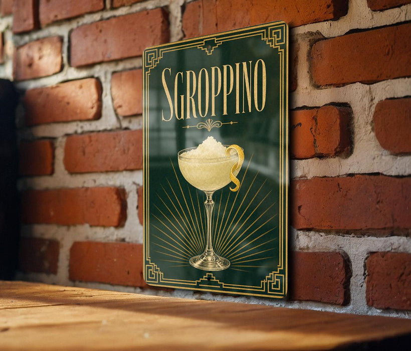 A sign for "SGROPPINO" cocktail is displayed on a brick wall, featuring an illustration of a cocktail glass with a lemon twist.