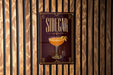 A sign for "Sidecar" cocktail is displayed on a wooden wall.