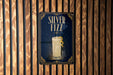 A poster for "Silver Fizz" cocktail, featuring a glass illustration and the text "Silver Fizz" prominently displayed.